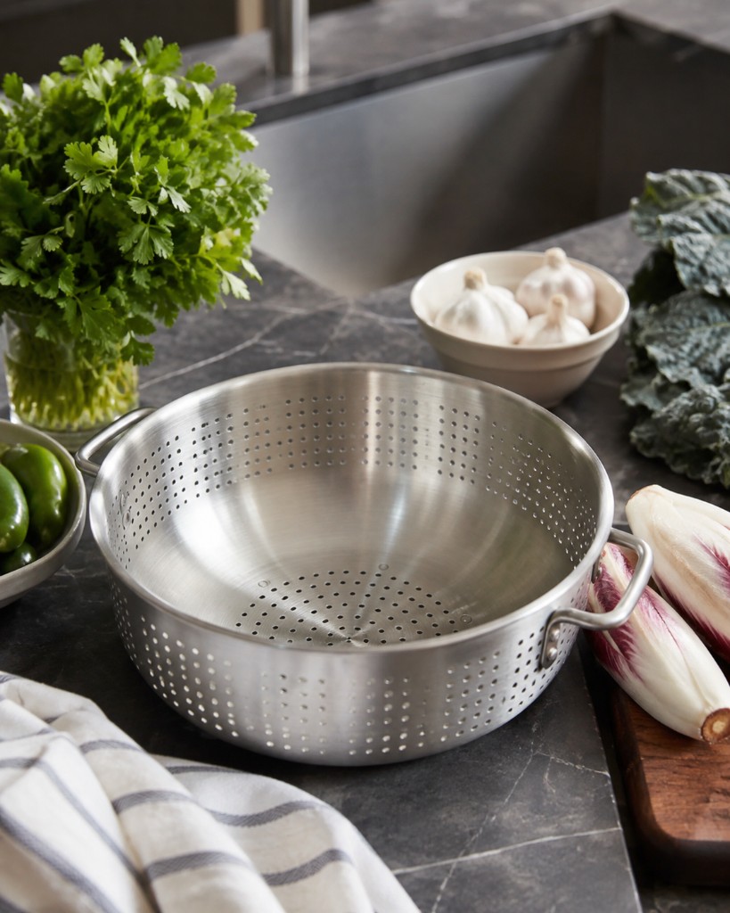 Stainless steel colander on a marble kitchen counter